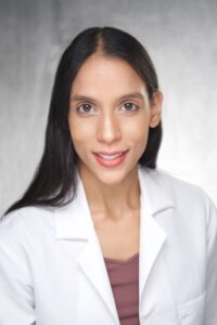 Dr. Chaudhry in a white lab coat